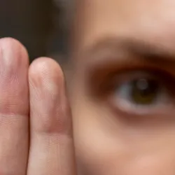 A mental health counselor holding up two fingers in front of a patient