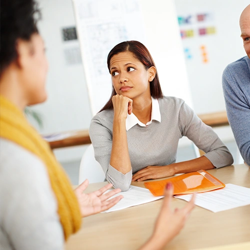 Woman struggles with distraction and ADHD in a meeting